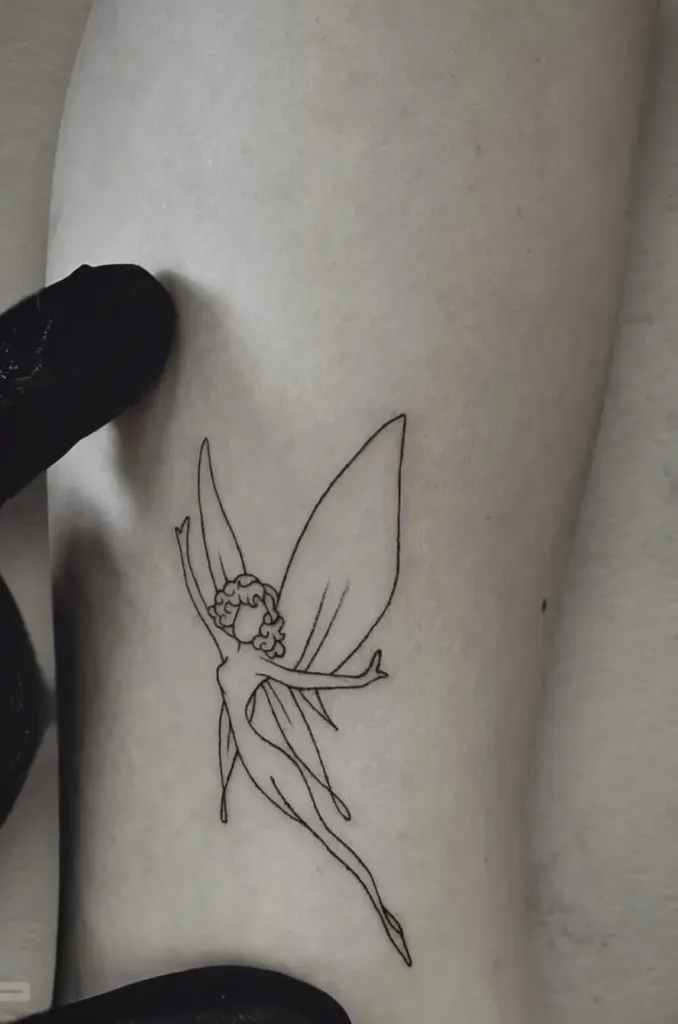 an image of a fairy tattooed on an arm showcasing fine line tattoo in Miami