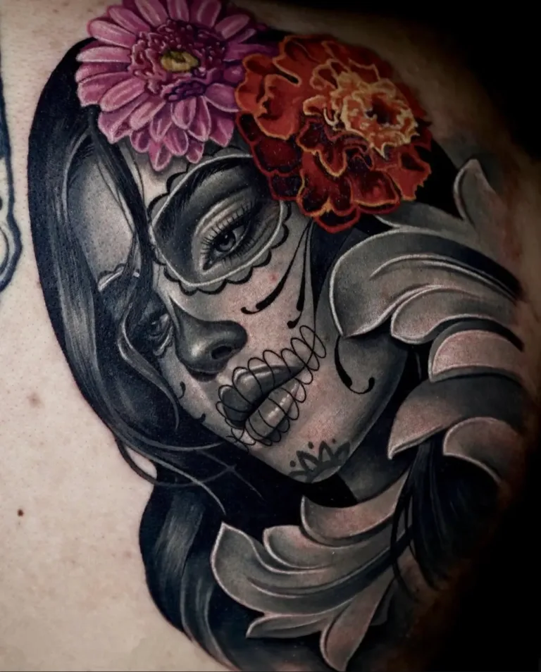 an image of a woman with red and plink flowers on her head showcasing realism tattoo artist in Tampa