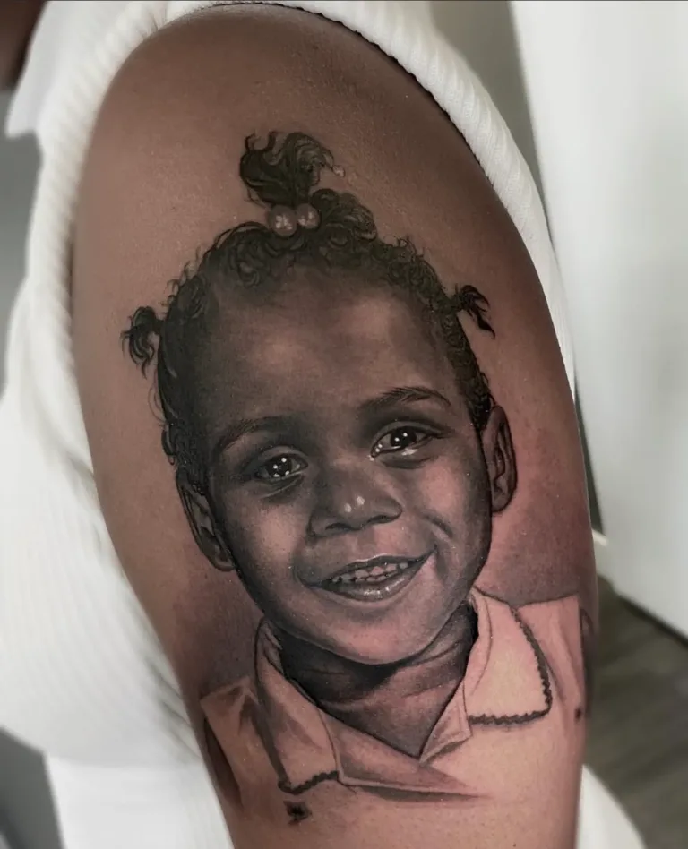an image of a young girl tattooed on a woman's arm showcasing a portrait tattoo artist in Miami