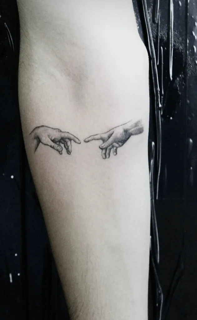 an image of two hands touching showcasing a fine line tattoo in Tampa